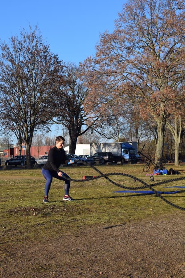Battle ropes conditioning session in a sunlit park