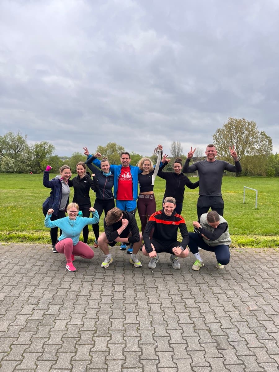 Outdoor training group posing after a strength session